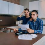 Unemployed young couple with debts reviewing their bank accounts